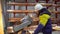 Industrial worker in hard hat working with circular saw in factory, Construction worker grinding, sawing metal