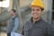 Industrial worker with hardhat on smiling
