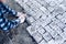 Industrial worker installing pavement rocks, cobblestone blocks