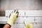 industrial worker installing small ceramic tiles in bathroom during renovation works