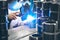 Industrial worker in manufacturing plant grinding to finish a Metal pipe