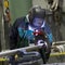 Industrial worker setting orbital welding machine.