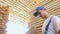 Industrial worker in uniform checking large wooden box on tablet in warehouse