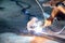 Industrial worker using welder machine is welding a spade tool