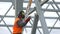 Industrial worker welding of metal structures, welder man male worker soldering steel beam structure on new building on