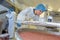 Industrial workers checking on vats in factory