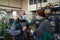 Industrial workers with face masks protected against corona virus discussing about production in factory. People working