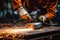 Industrial workers in a factory welding steel structure with sparks. Metalwork manufacturing