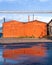 Industrial zone in the city, reflection of a orange garages