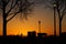 Industrious Squirrel Starts His Busy Day At Dawn in a Serene Orange Lakeside Park Silhouette