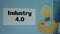 Industry 4.0 inscription on blue background. Graphic presentation with drawing of burning light bulb as symbol of