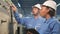 Industry engineer teams inspect machine control panels in manufacturing factory.