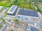 Industry with low carbon footprint. Industrial warehouses with solar panels on the roof. Technology park and factories from above