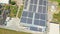 Industry with low carbon footprint. Industrial warehouses with solar panels on the roof. Technology park and factories from above