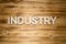 Industry word made of wooden block letters on wooden board