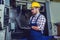 Industry Worker entering data in CNC machine at factory.