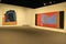 Inetersting paintings hanging on stark walls of room, State Museum, Albany, New York, 2017
