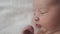 Infancy, childhood, development, medicine and health concept - close-up from above face of newborn awake baby