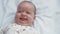 Infancy, childhood, development, medicine and health concept - close-up top view face newborn awake lively playful