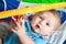 Infant baby boy playing on activity mat