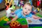 Infant baby boy playing on activity mat