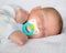 Infant baby boy sleeping with pacifier