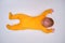 Infant baby lies on a play mat in yellow pajamas, top view. Toddler on the white floor full length, copy space