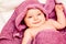 Infant baby in violet towel