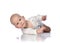 Infant child baby boy toddler in white bodysuit is lying on its side, trying to roll over on white