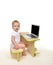 Infant child baby girl toddler sitting with modern wireless comp