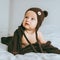 infant child in brown knitted hat with blanket