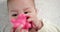 infant, childhood concept - close-up of smiling happy Baby plays with a teether. Teeth cutting. First teeth. Joy