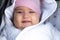 Infant, childhood, emotion concept - close-up of cute smiling portrait face of brown-eyed chubby newborn awake toothless