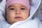 Infant, childhood, emotion concept - close-up of cute smiling portrait face of brown-eyed chubby newborn awake toothless