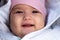 Infant, childhood, emotion concept - close-up of cute smiling portrait face of brown-eyed chubby newborn awake toothless