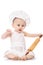 Infant cook baby in the cook costume and chef hat with dough rolling pin, isolated on a white background
