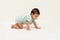 infant crawling on floor inside baby playpen