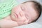 Infant cute baby sleeping portrait lying on arms