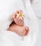 Infant foot with little white daisy
