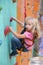 Infant girl making first steps on climbing wall