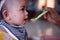 Infant girls eating mashed potatoes mixed with water