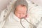 Infant with gray hat on napping, closeup