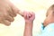 Infant gripping parents finger