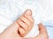 Infant holding mother\'s hand