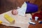 Infant laying on creative background with repairing tools