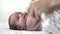 Infant, motherhood, development, childhood, training, pediatrics, medicine and health concept - close-up newborn