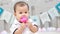 Infant sitting play with ball in nursery