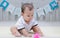 Infant sitting play with ball in nursery