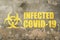 Infected covid-19 sign, old grange plastered brick wall with written text, outbreak alert sign