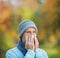 Infected man blowing his nose in tissue paper